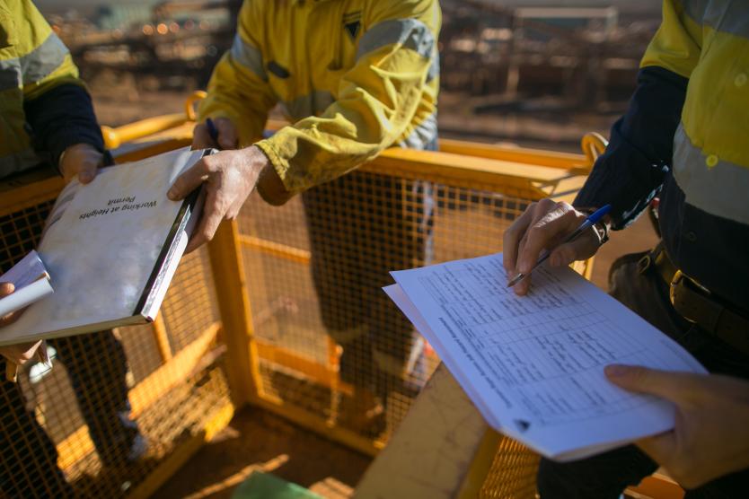 Workers on site going through documents